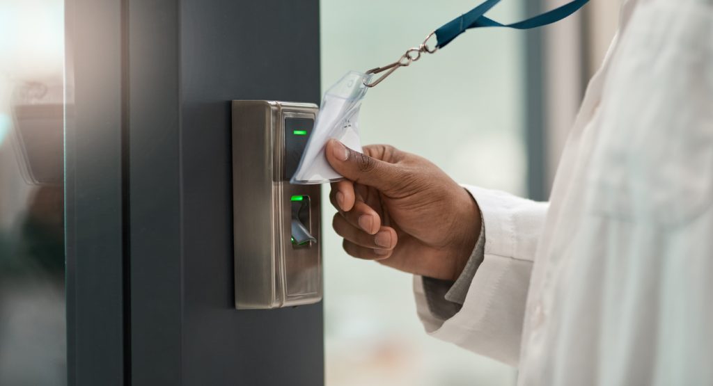 Closeup shot of an unrecognisable scientist using an access card to gain entry at a door